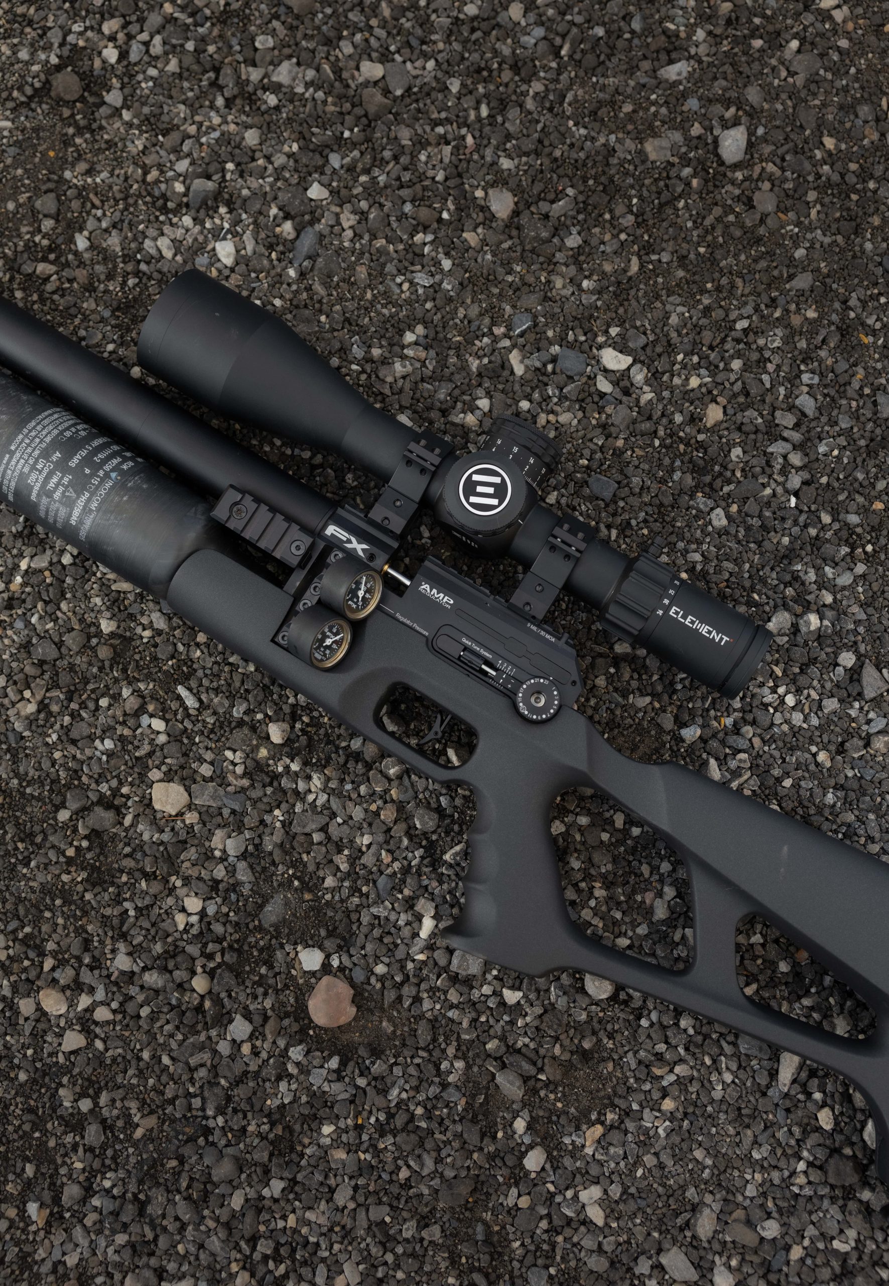 An air rifle on the floor in a flat lay