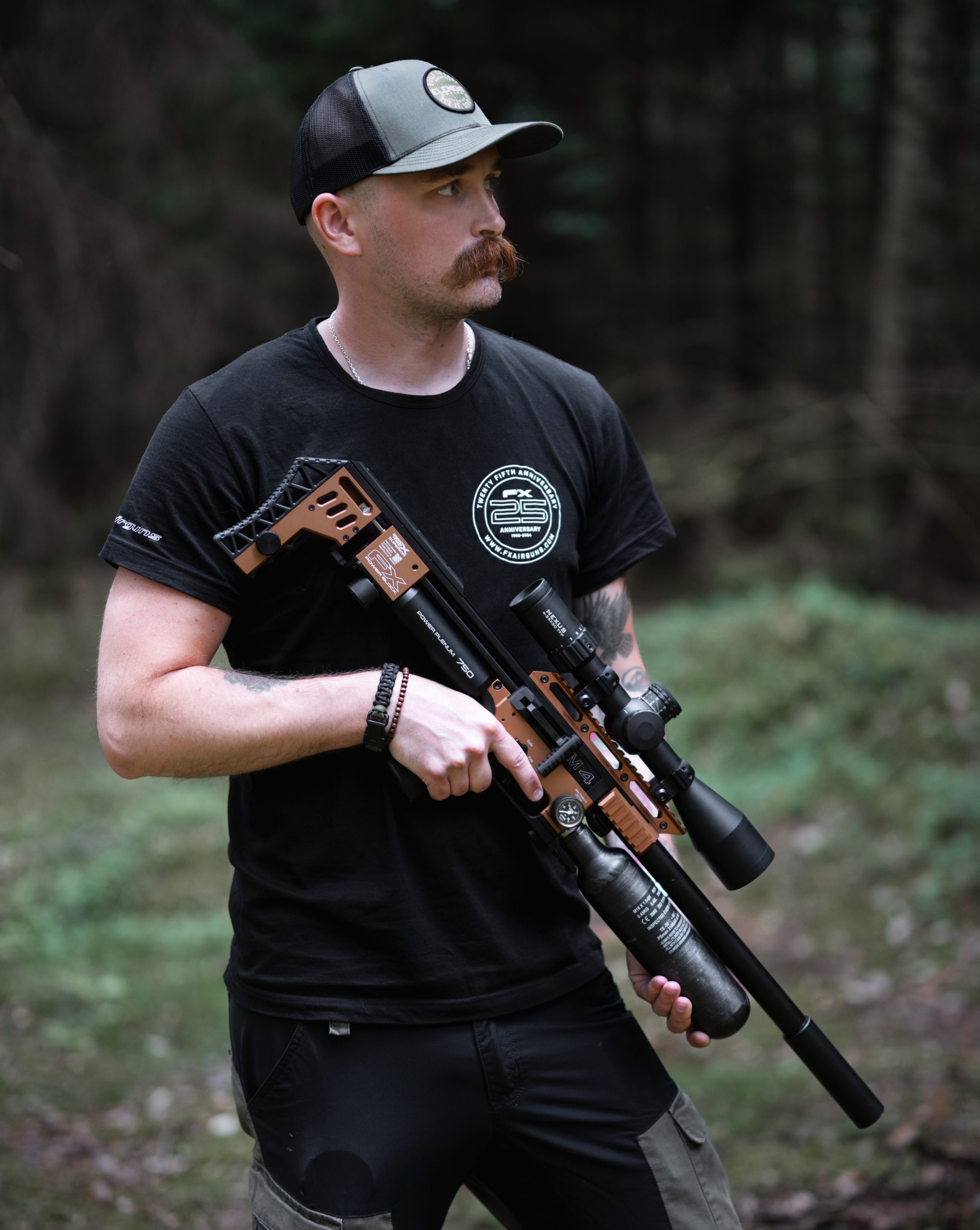 Man standing and holding an air rifle