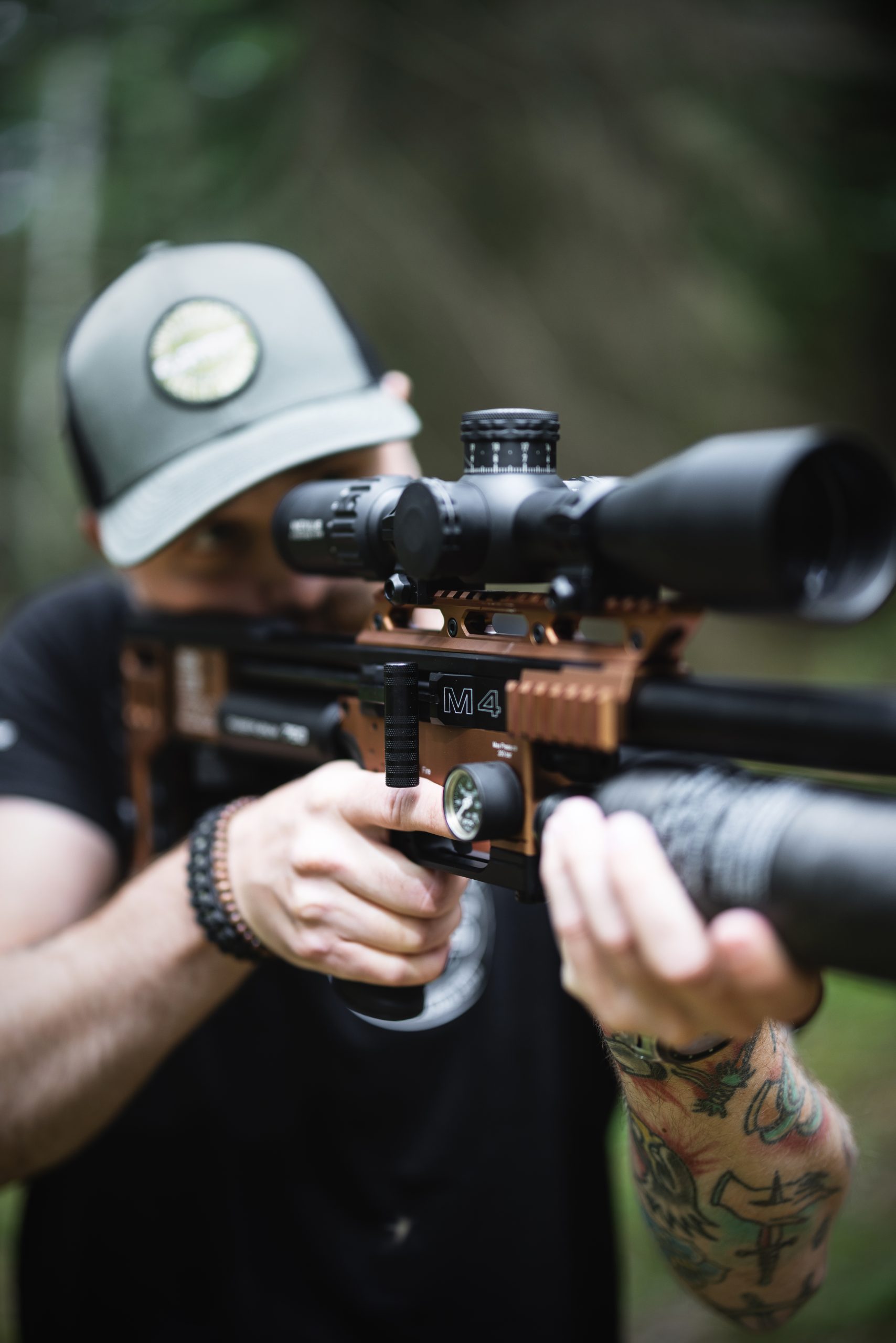 Man looking through the scope of an air rifle