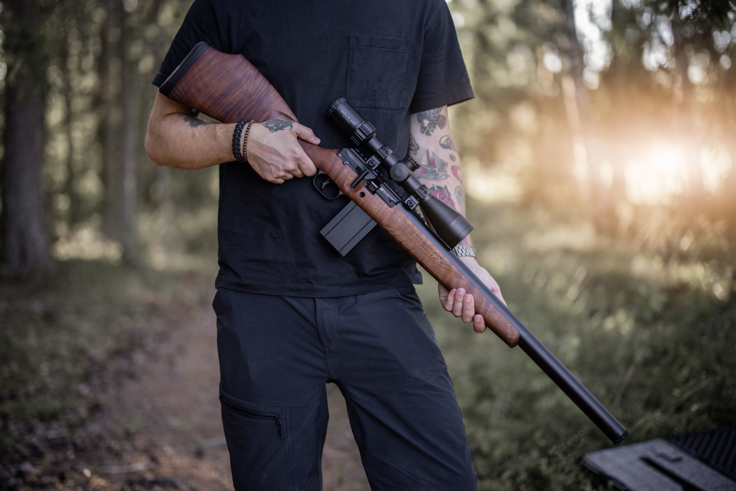 Man stood holding an air rifle