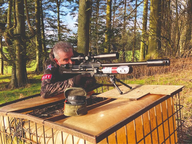 Mick Garvey shooting an air rifle from a bench