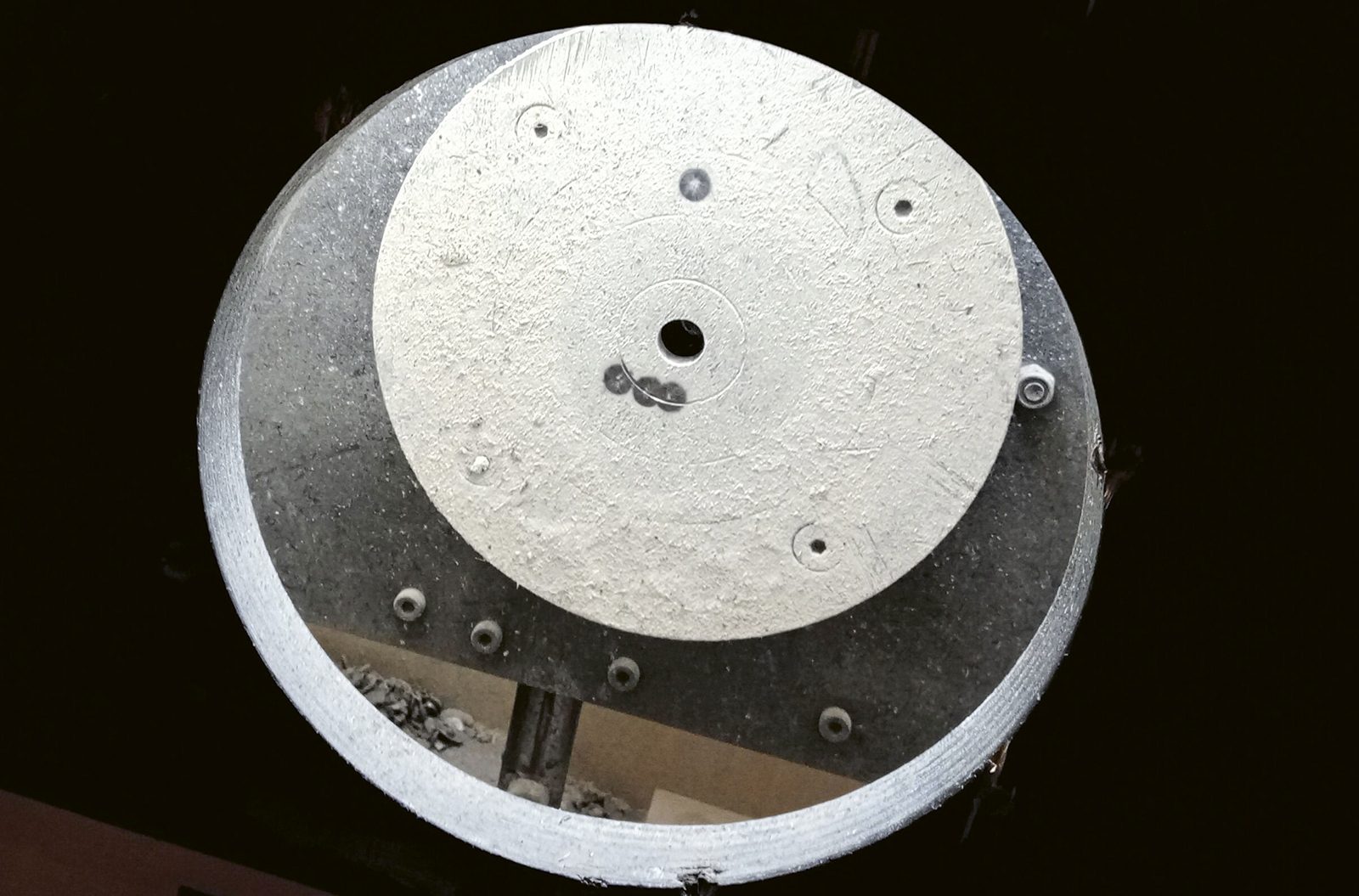 Close-up of a bell target showing the 3/8 inch bull hole at the centre of concentric scoring rings
