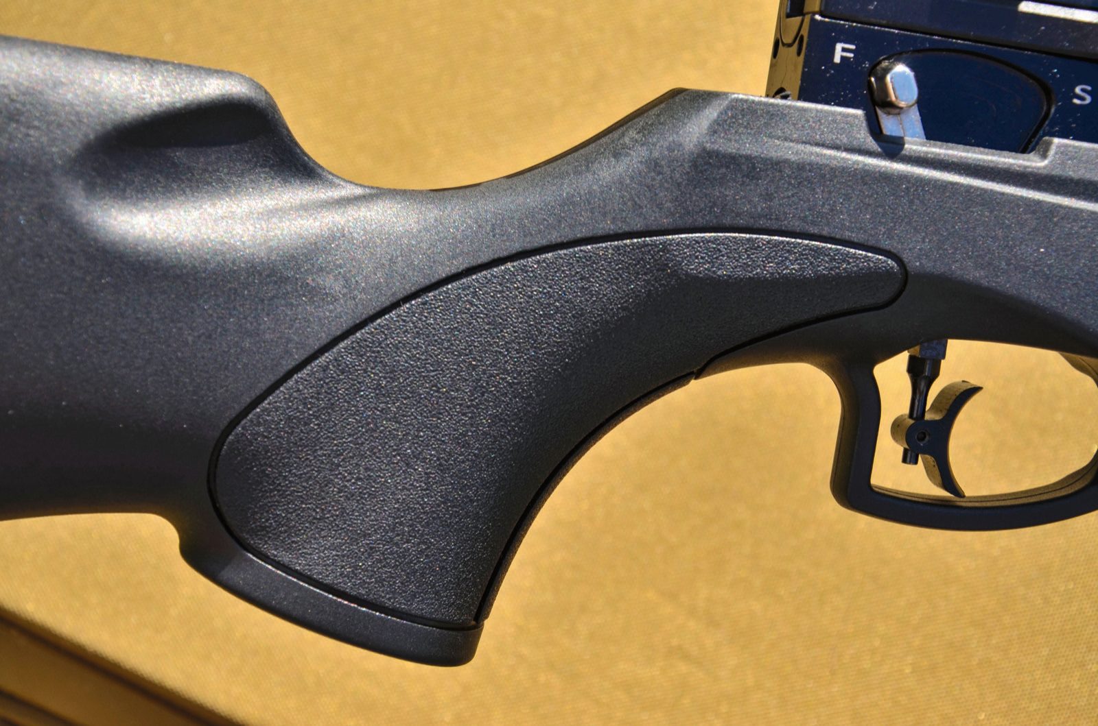 Moulded synthetic stock grip of the EB Arms Agincourt Synthetic with stippled panels